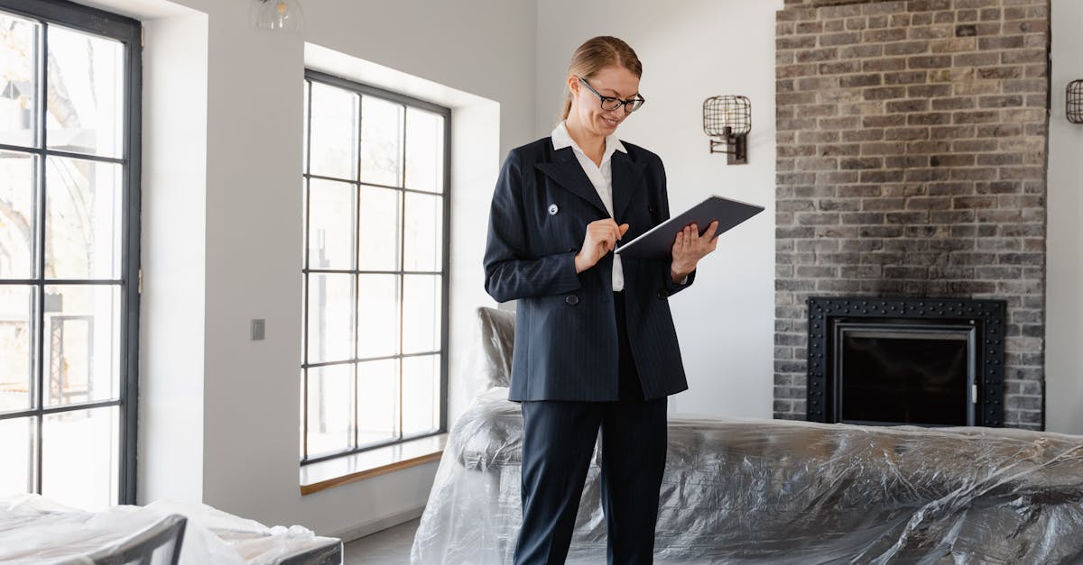 Real estate agent in a suit reviewing paperwork inside a newly renovated home.